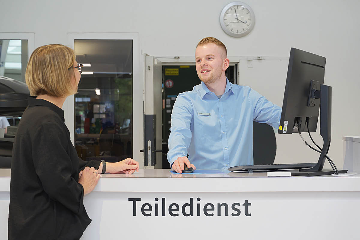 Teiledienstservice-Mitarbeiter berät eine Kundin